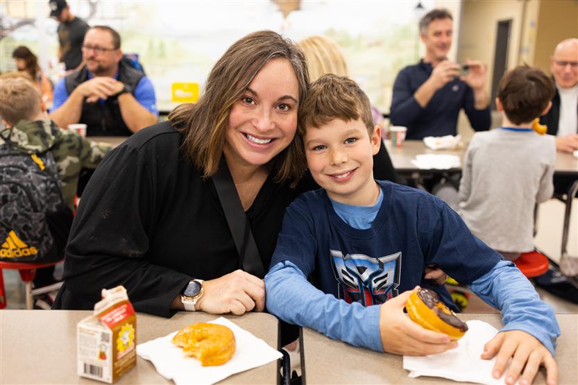 Students and their families enjoy donuts